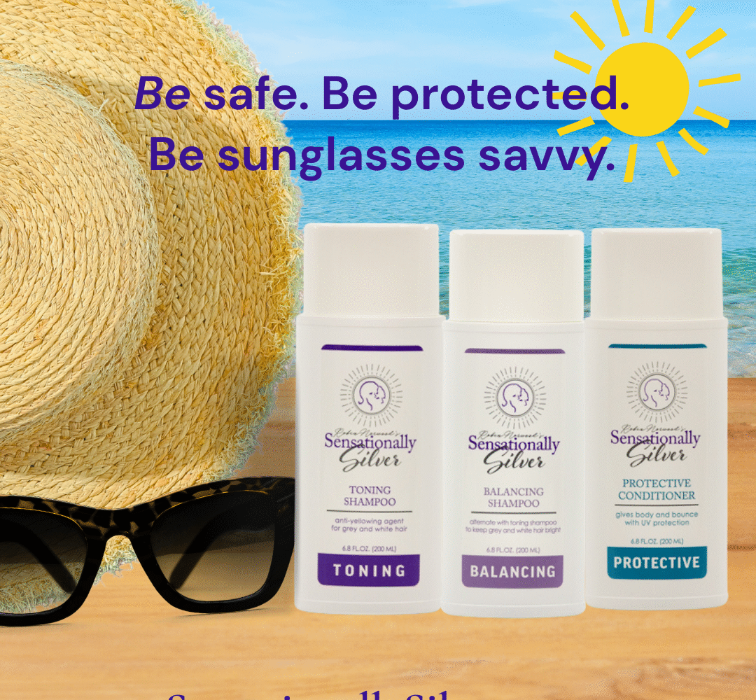 Sensationally Silver hair care products displayed with sunglasses and a sun hat by the ocean, promoting UV protection for National Sunglasses Day.